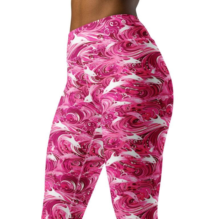 Pink scuba diving leggings with white dolphins printed on them
